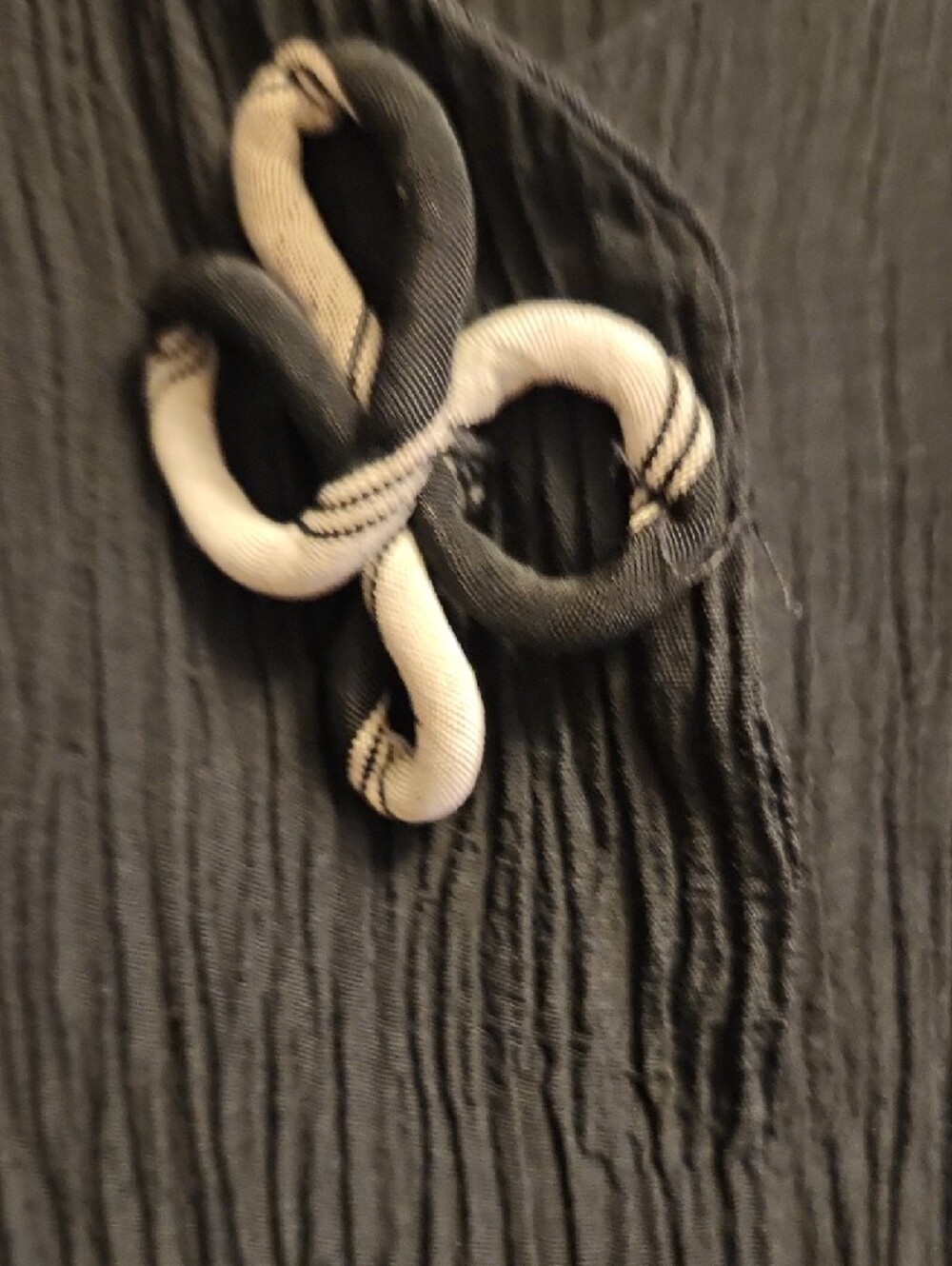 Black Crinkle Sleeveless V-Neck Vest with Decorative Large Unique Swirl Buttons - Picture 5 of 6